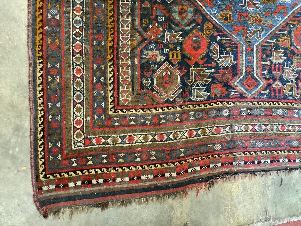 An early 20th century Shiraz blue ground carpet, 310 x 170cm